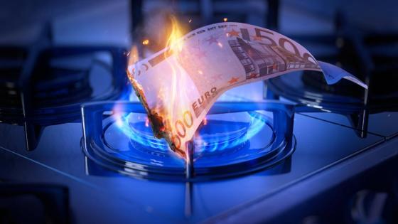 A 50 euro note burns atop a stove