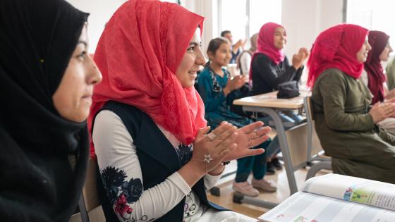 Syrian female students clap during a Turkish language course in the Altindag Public Education Centre in Ankara, Turkey