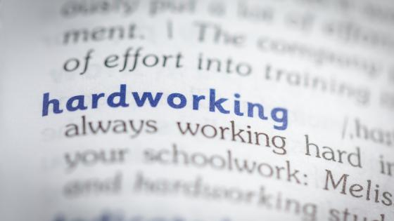 Close up of entry for "hardworking" in dictionary