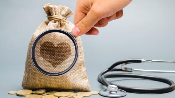 Money bag and heart image with stethoscope.