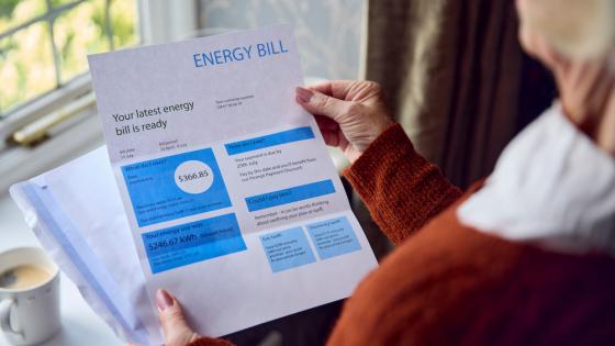 Close Up Of Senior Woman Opening Energy Bill 