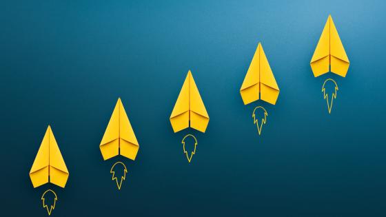 Yellow paper planes on blue background