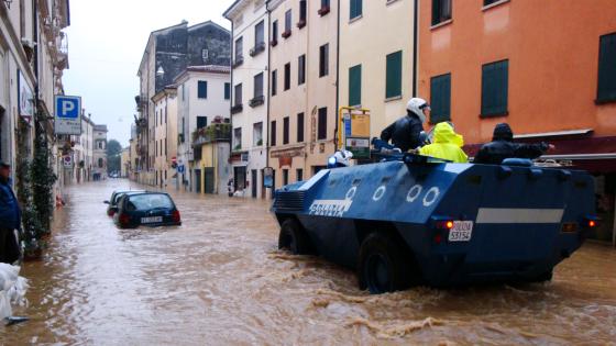 A police vehicle patrols a flooded street in Vicenza, Italy