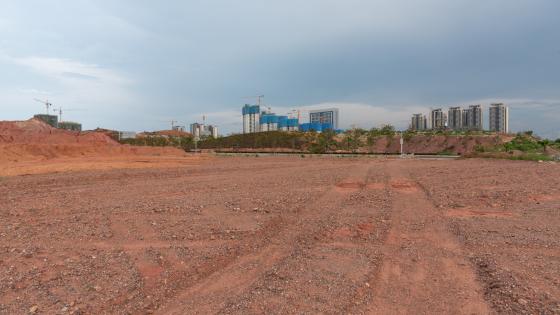 Plot of land with apartments in background