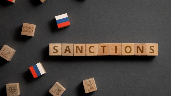 Russian flags and the word "sanctions" on wooden cubes