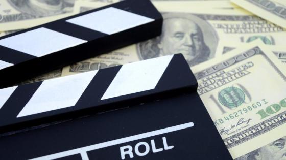 Film slate lying on dollars