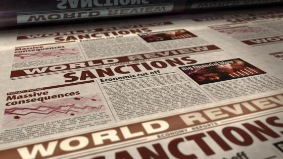 A newspaper reel with the word 'sanctions' in bold headline