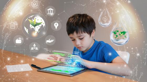 Boy using tablet to research about Kid using tablet research on internet about world population, ecology and the environment
