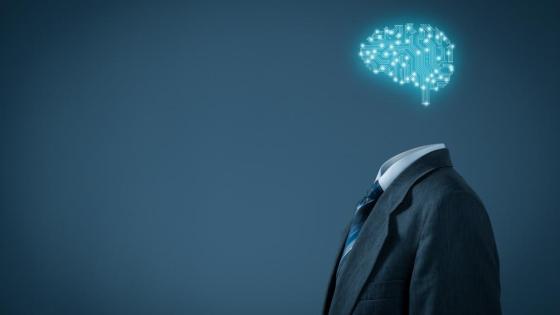 A computer generated brain hovers above a headless suit