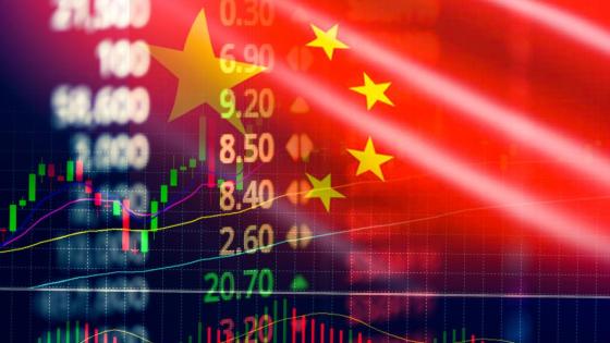 The Chinese flag fades into an image of stocks on a screen
