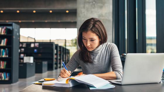 Female student studying at college library