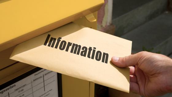 Envelope marked "information" being posted