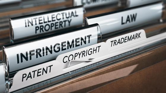 Files in cabinet labelled intellectual property, infringement, copyright and patent