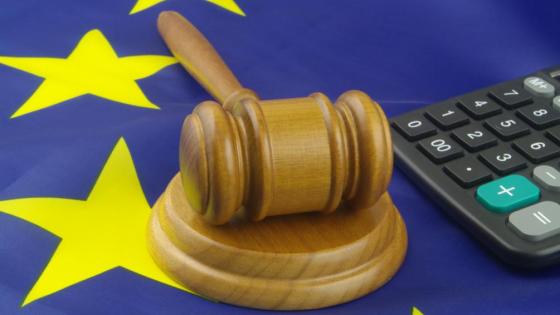 A judge's hammer lies on the EU flag