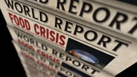 A newspaper reel shows headline 'World Report: Food Crisis'