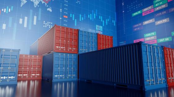 A stack of shipping containers lie against a backdrop of graphs and charts