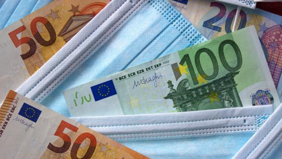 Euro currency close up and medical mask as a symbol of coronavirus