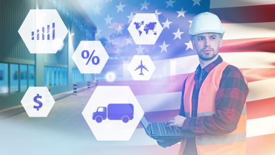 Man with laptop in hard hat in front American flag with trade-related icons