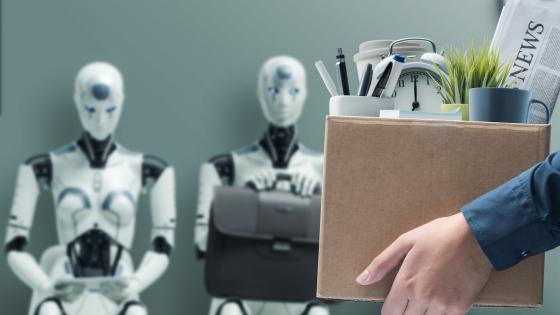 Person leaving job with possessions in box, with robots in background