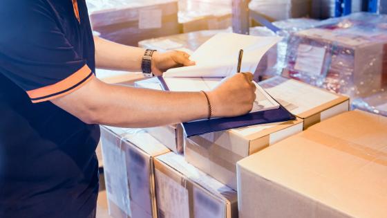 Warehouse worker checking forms