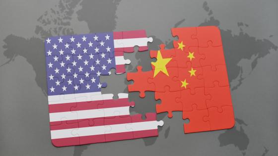 puzzle with the national flag of united states of america and china on a world map background