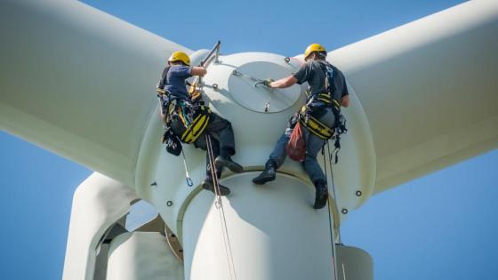 Men work on a wind turbine 