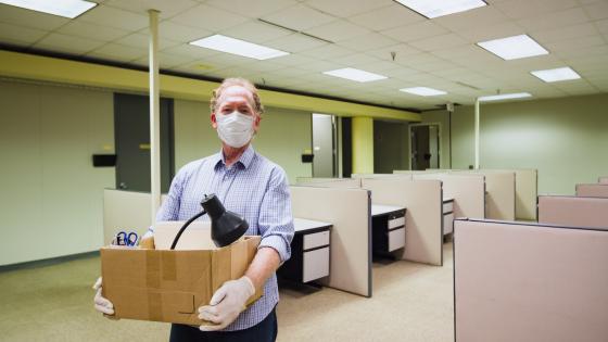 Man leaving job business office closed due to Covid-19 Coronavirus