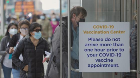 People walking into mass Covid 19 vaccination site place in New York City