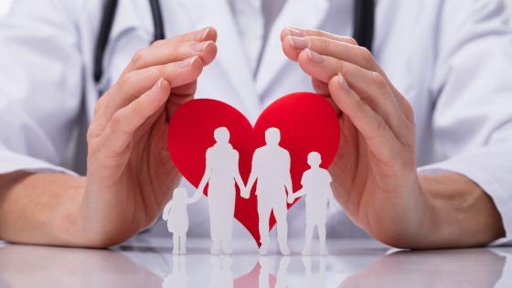 Doctor Protecting Family Cut Out With Heart Shape