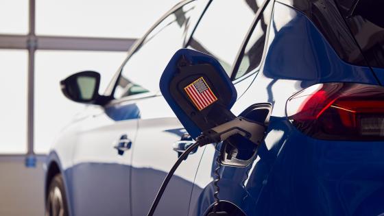 Charging Cable Attached To  Electric Car With US Flag Sticker