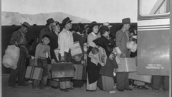 Japanese-Americans transferring from train to bus at Lone Pine, California, bound for war relocation authority center at Manzanar