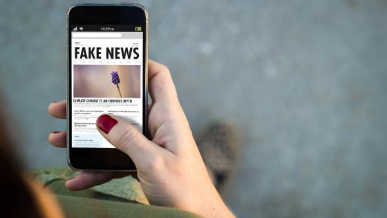 Woman reading fake news on mobile phone 