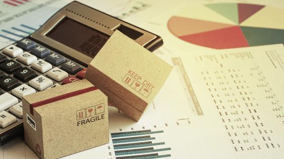 packaging boxes, calculator and financial charts